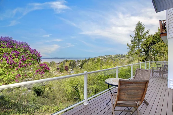 Groot terras met meubilair en water uitzicht over green. — Stockfoto