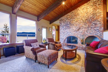 Beautiful rustic livingroom with fireplace and wood ceiling. clipart