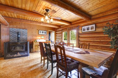 Log cabin living room with stove. clipart