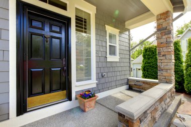 Grey house exterior with black door. clipart