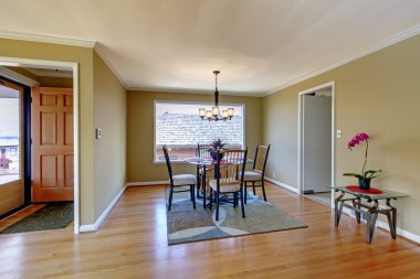 Dining room with flont door and hardwood floor. clipart