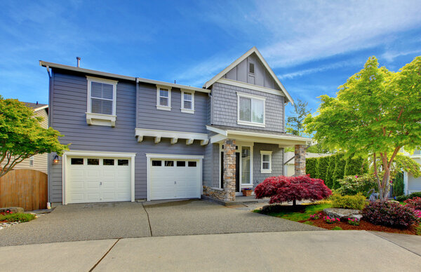 Grey American house with two garage doors.