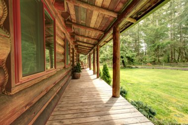 Front porch of the old rustic log cabin. clipart