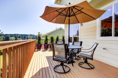 Deck with table, chairs and umbrella. clipart