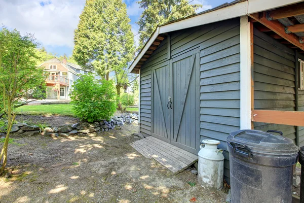 Grey shed with house on the back. — Stock Photo, Image