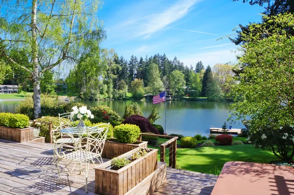 Beautiful deck near lake with spring landscape. — Stock Photo, Image