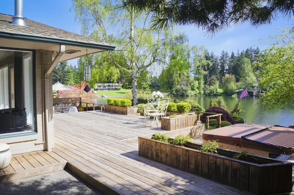 Spring deck and house view with lake and tub. — Stock Photo, Image