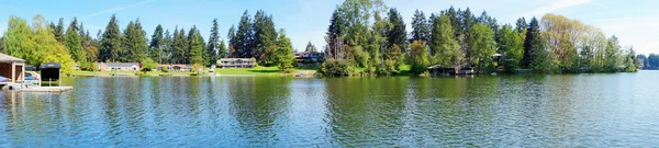 stock image Spring lake with houses panorama.