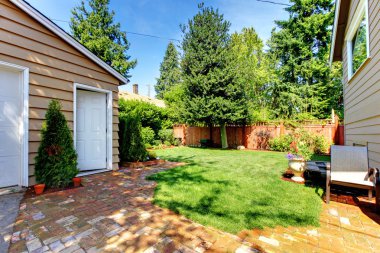 Backyard with house and garage and two doors. clipart