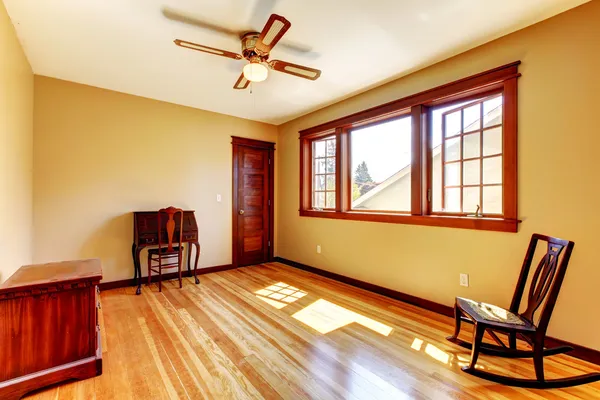 Lege ruimte met gele muren en hardhouten vloer. — Stockfoto