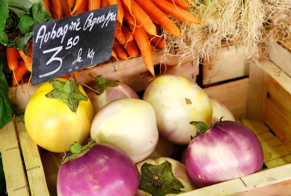 stock image Eggplant and carrots at the outdoor market in te box.