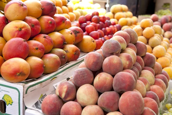 stock image Mango and peaches fruit at the outdoor market.