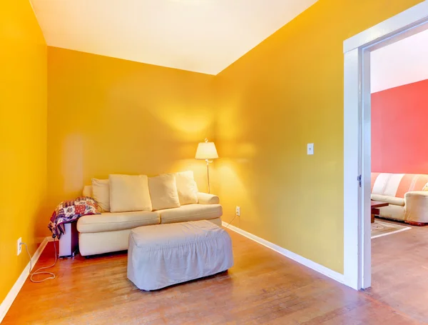 Pomarańczowy i różowy pokoje z sofy i podłogi. — Zdjęcie stockowe