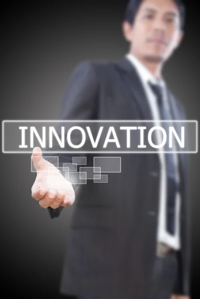 Podnikatel drží innovationword na tabuli. — Stock fotografie
