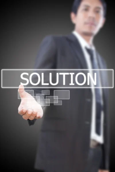 Businessman holding Solution word on the whiteboard. Stock Image