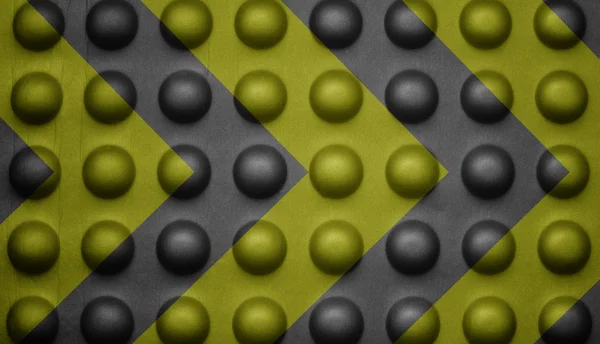 Yellow and black warning sign on bubble texture.