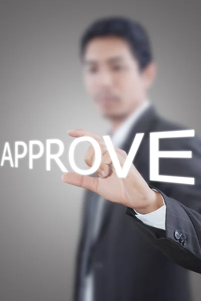 Asian businessman pushing approve word on a touch screen interface — Stock Photo, Image