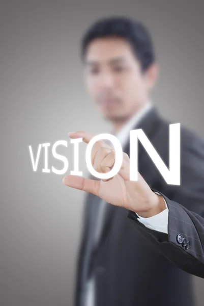 Hombre de negocios asiático empujando palabra de visión en una interfaz de pantalla táctil —  Fotos de Stock