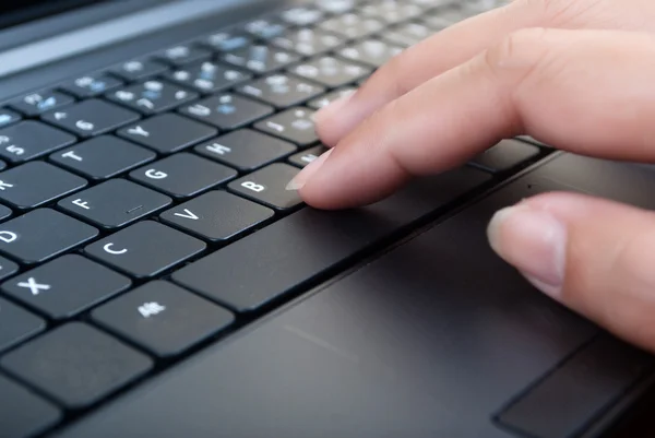 Hand pushing laptop keyboard — Stock Photo, Image