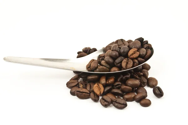 Cuillère mettant les grains de café isolés sur le blanc . — Photo