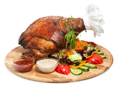 Delicious roasted pork leg with vegetables clipart