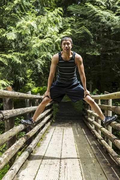 stock image Athletic Young Man on Wooden Bridge