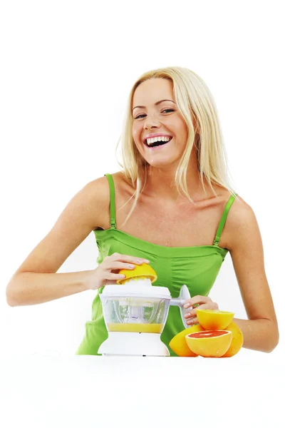 Fitness woman make an orange juice — Stock Photo, Image
