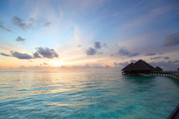 Maldivian houses on sunrise — Stock Photo, Image