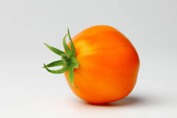Orange tomato on white — Stock Photo, Image
