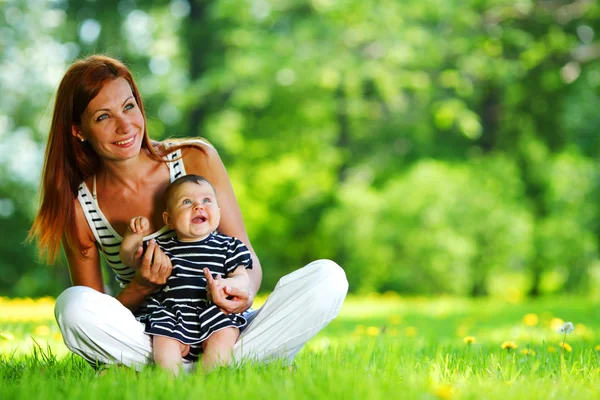 Anne ve kızı yeşil çimenlerin üzerinde — Stok fotoğraf