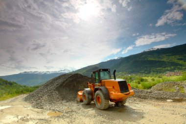 Excavator in alps clipart