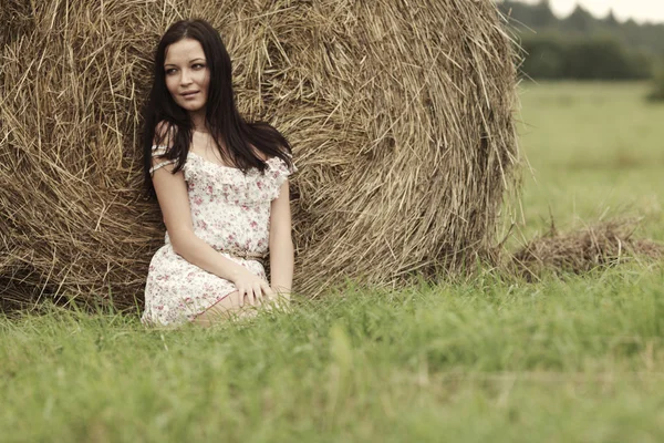 Girl next to haystack — Stock Photo, Image