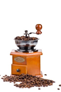 Coffee grinder with coffee beans on isolated white background clipart