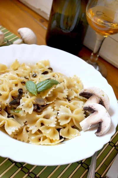 stock image Pasta farfalle with champignon and basil