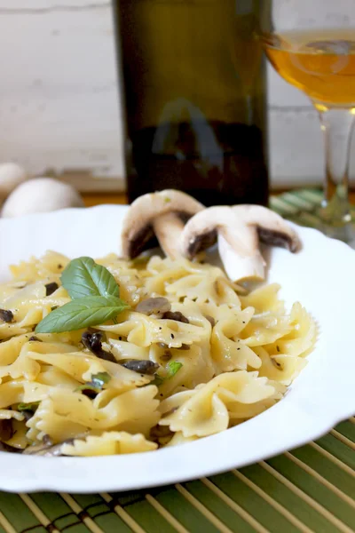 stock image Pasta farfalle with champignon and basil