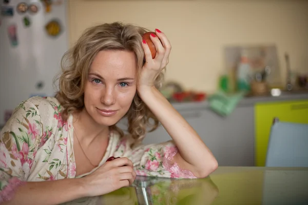 stock image Girl with apple sitting at the table