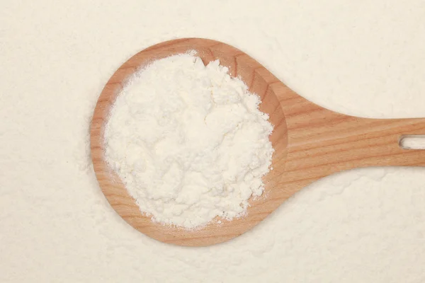 Flour on a wooden spoon — Stock Photo, Image