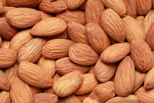 Almonds form a background — Stock Photo, Image