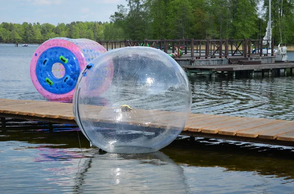 Zorbing air bubbles on water. Pier lake Trakai — Stock Photo, Image