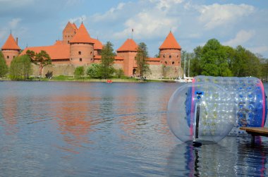 Zorbing on water near Trakai castle Galve lake clipart