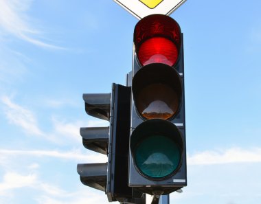 Red color traffic light blue sky in background clipart