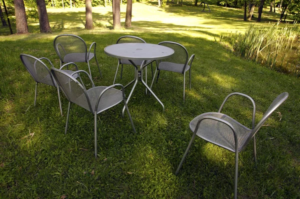 Chairs made of metal steel on meadow grass — Stock Photo, Image