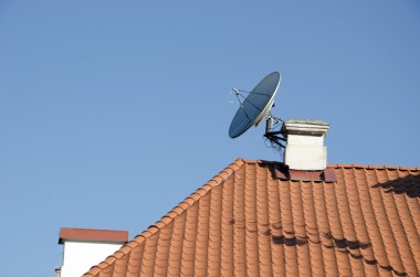 Satellite television antenna attached to chimney clipart