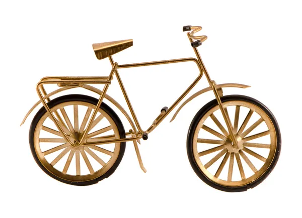 Piccola bicicletta giocattolo color oro isolata su bianco — Foto Stock