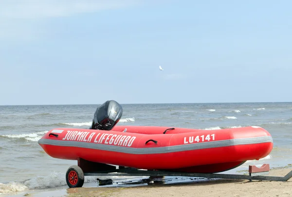 Rubber lifeguard boat trailer on sea shore — Stock Photo, Image