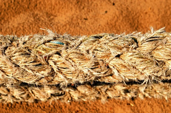 Thick synthetic rope and sea sand on background — Stock Photo, Image