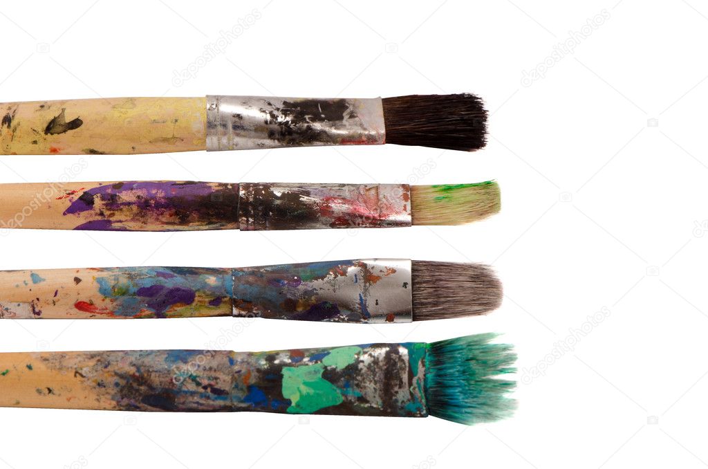 Dirty wooden paint brushes isolated on white