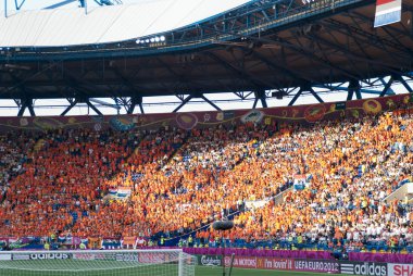 Netherlands fans on stadium before beginning of match clipart