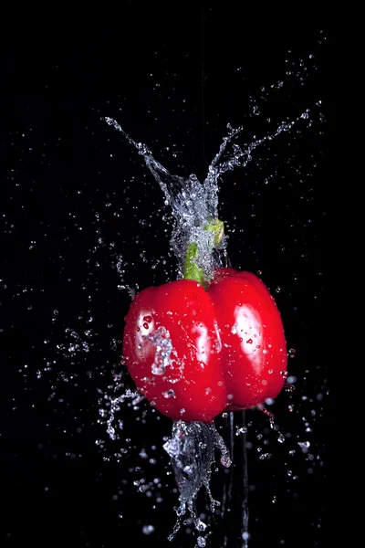 Pepper and splaching water. — Stock Photo, Image