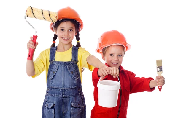 Kids in overalls with paint roller and paintbrush — Stock Photo, Image